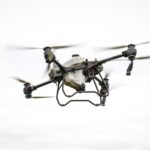 A drone surveying stockpiles in an industrial setting, showcasing advanced UAV technology for accurate volume measurement.